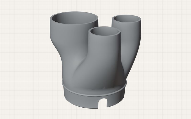 Graues CAD-Modell eines Heizungsadapters mit drei Abgängen auf einem Raster